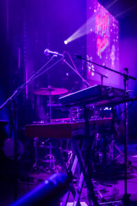backline equipment on stage with purple lighting